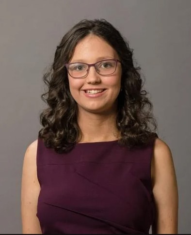 Aaliyah A. from Indiana Connections Academy wearing an eggplant purple dress smiling at the camera.