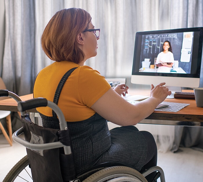 Parent in a wheel chair on the computer - Connections Academy