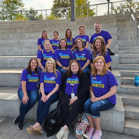 A group of Minnesota Connections Academy staff sitting together on steps at a field trip