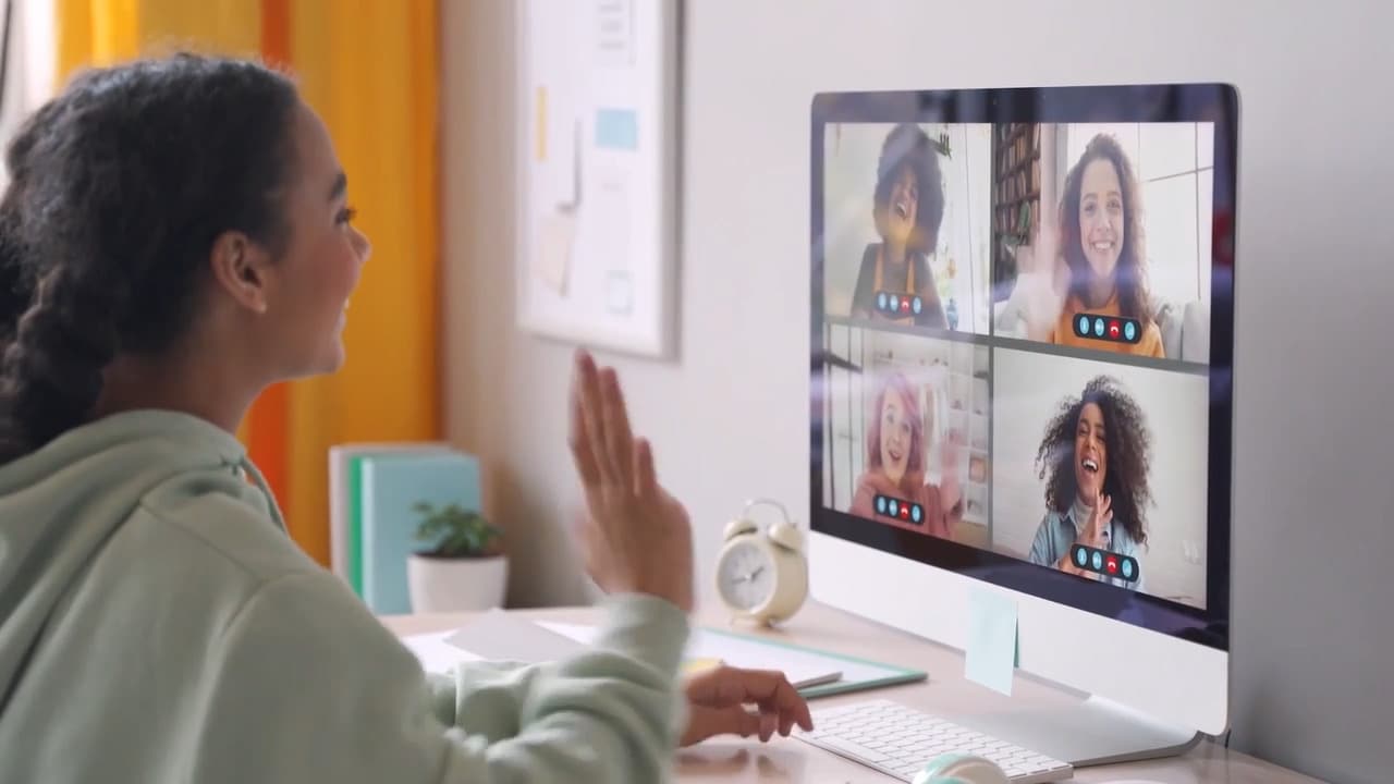 Connections Academy student waving to students and teachers on a video call